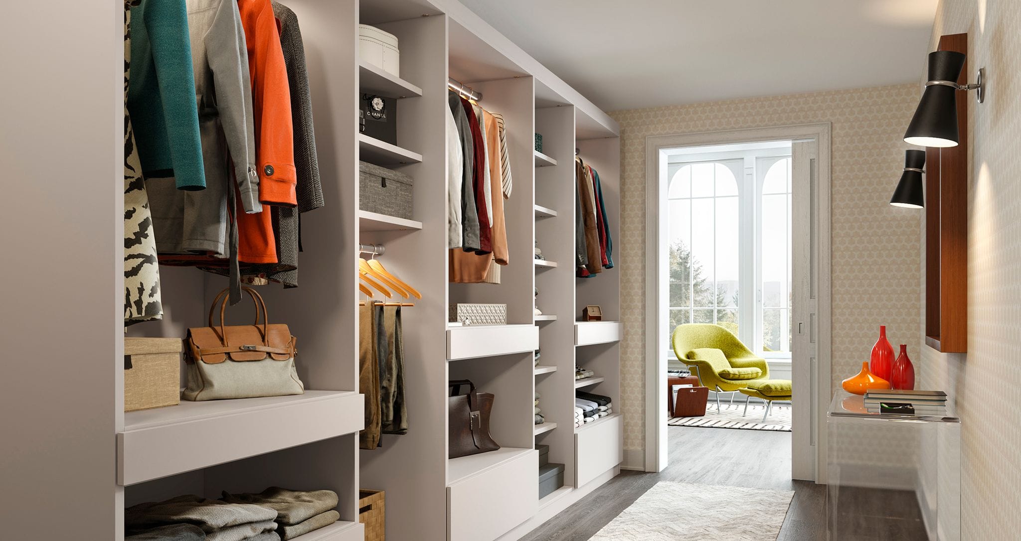 Walk in closet designed in a long hallway with floor to ceiling customized storage by California Closets