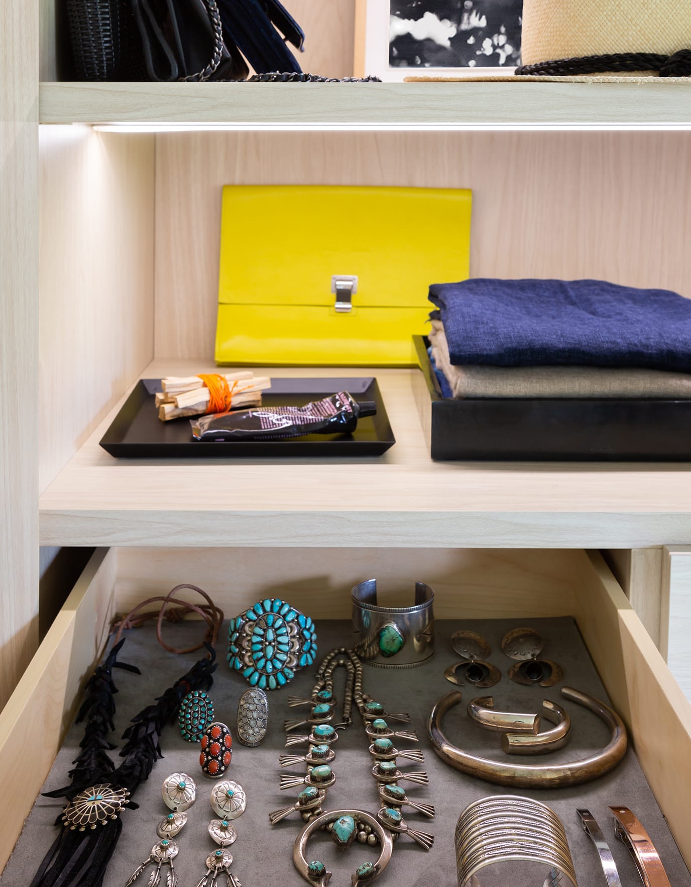Custom jewelry storage for Michelle Adams' reach in closet design in light wood finish by California Closets
