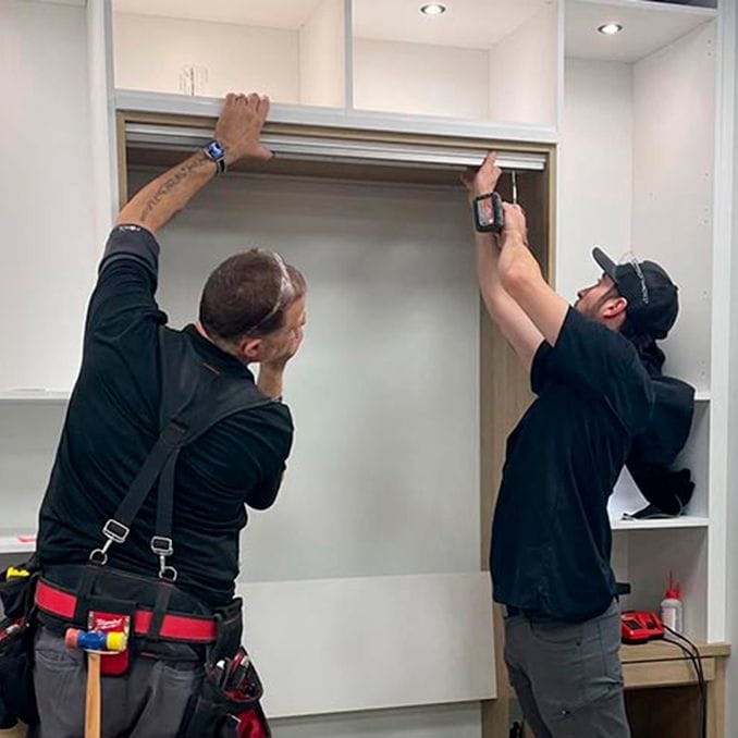 Installation process fitting shelving with LED lighting at a client's home from California Closets