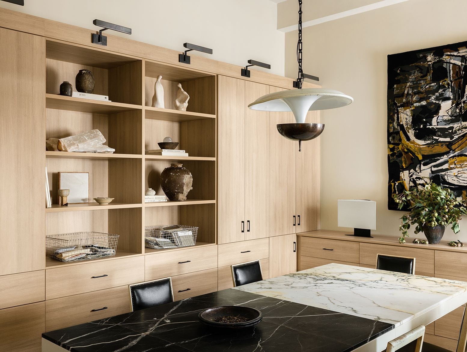 Jeremiah Brent's home office with light finish cabinetry, open shelving, and customized drawers for fabrics by California Closets