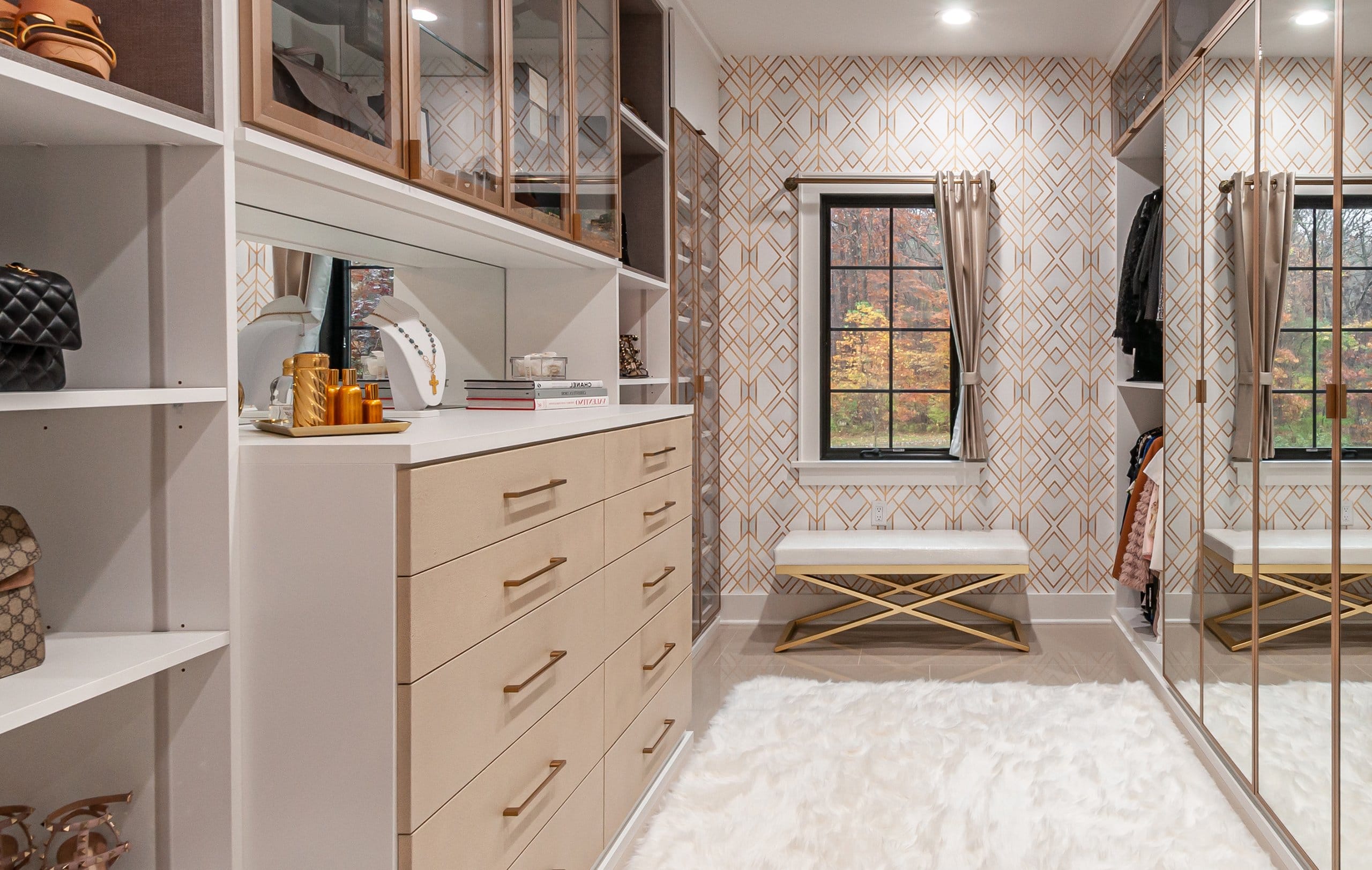 Master bedroom walk in closet designed for couple's New Jersey home by California Closets