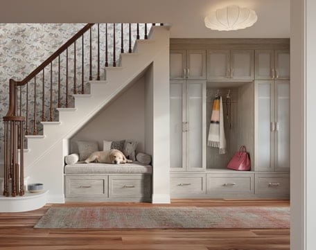 Entryway storage with custom cabinets and shelves and bench seating designs by California Closets